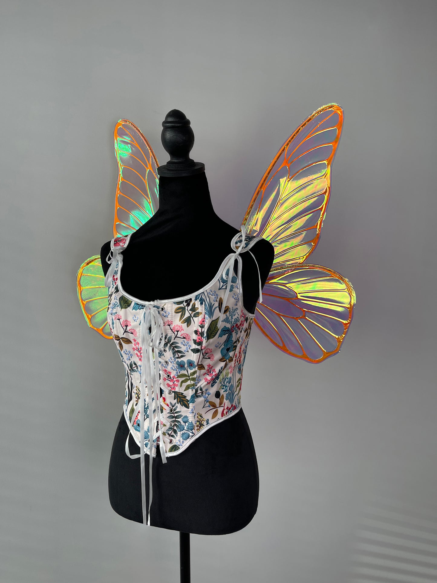 Butterfly colorful wings on a mannequin against a gray background