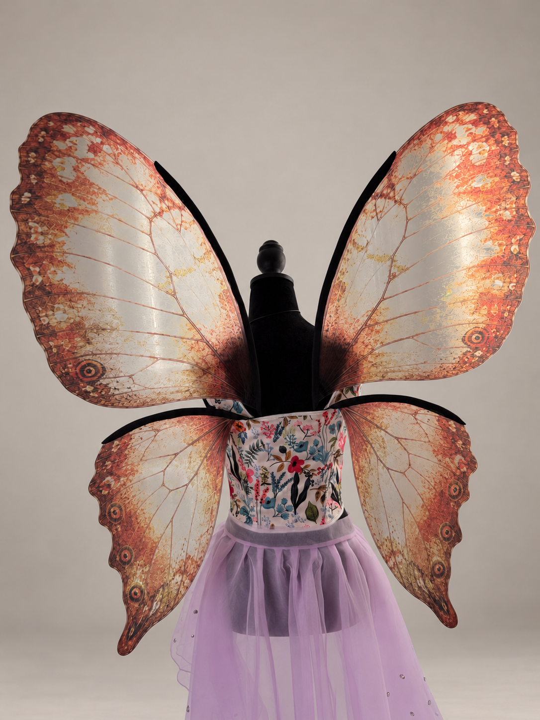 Adult fairy costume wings displayed on a floral corset