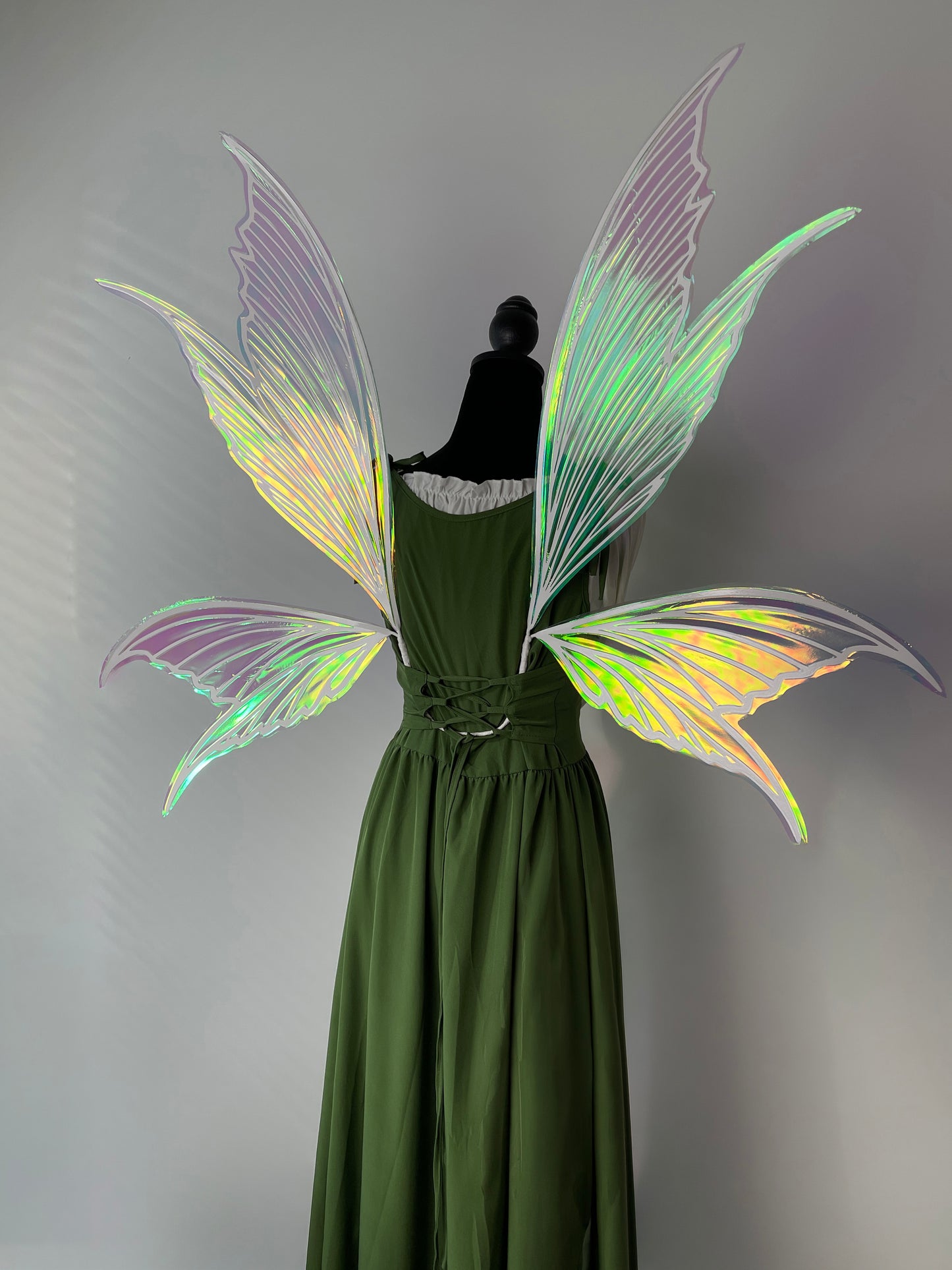 Iridescent cosplay wings reflecting rainbow light
