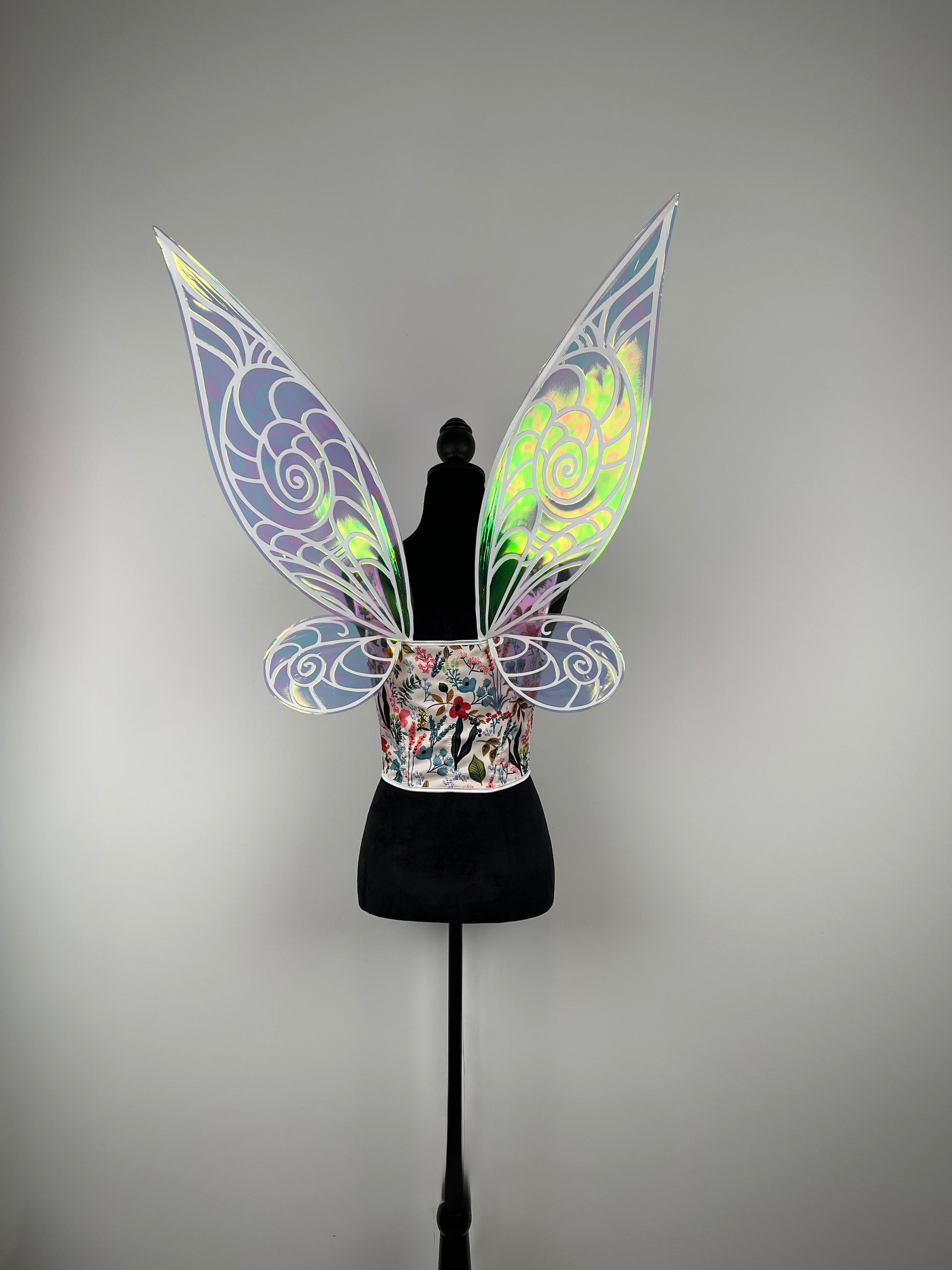 Decorative fairy wings costume for Halloween on a mannequin against a gray background