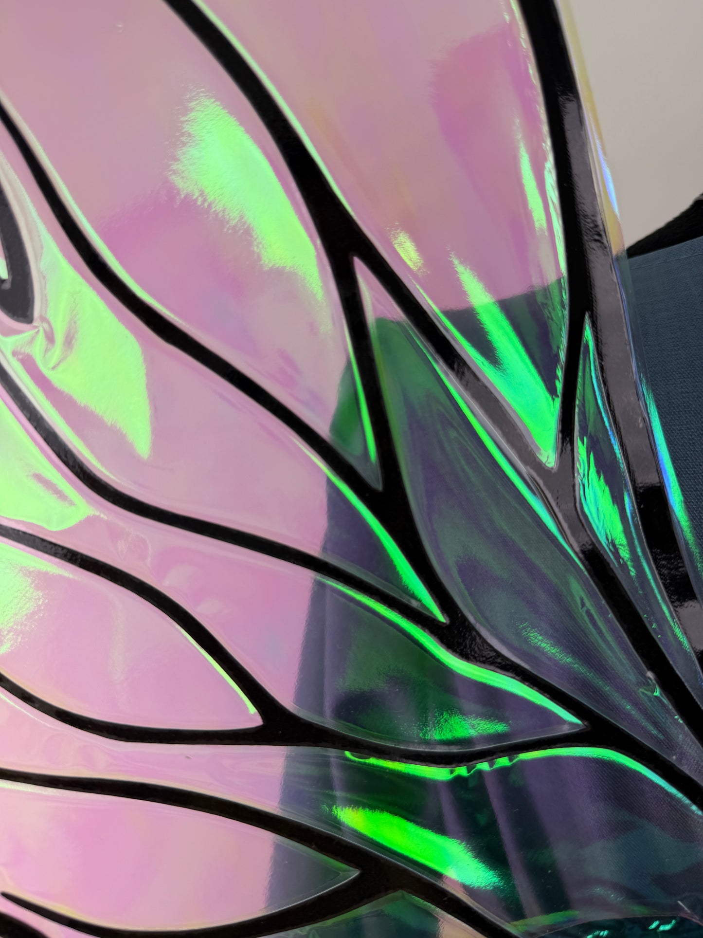 Dark fae wings with dramatic pointed shapes and vivid green and violet reflections