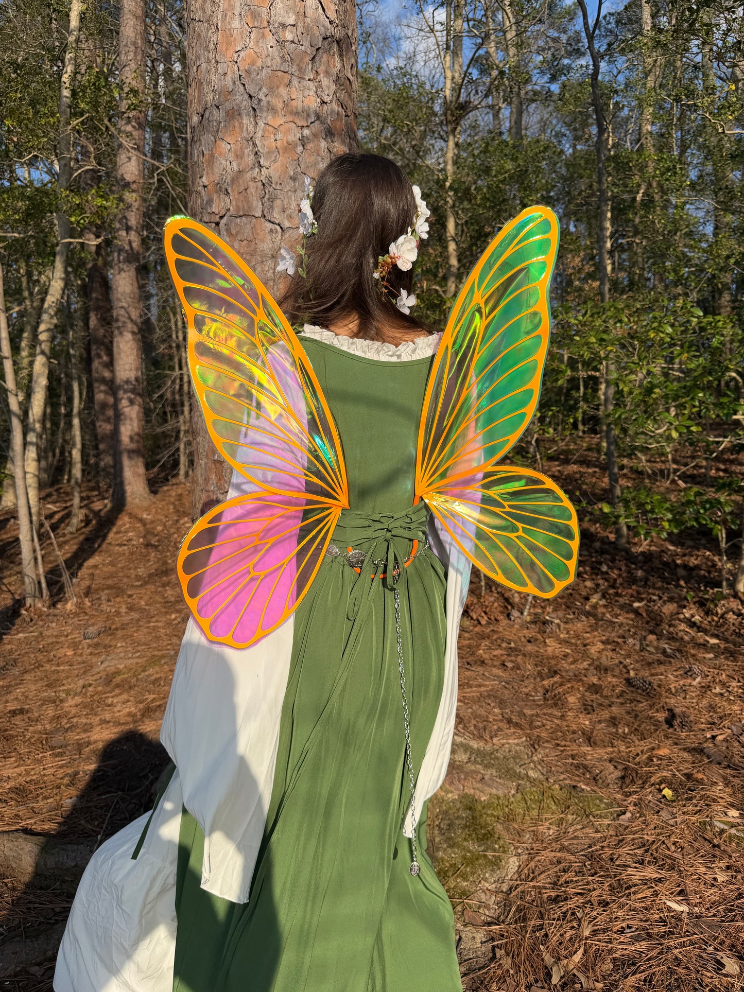 Fairy wings with bright orange veins worn in a forest, fantasy fairy costume accessory