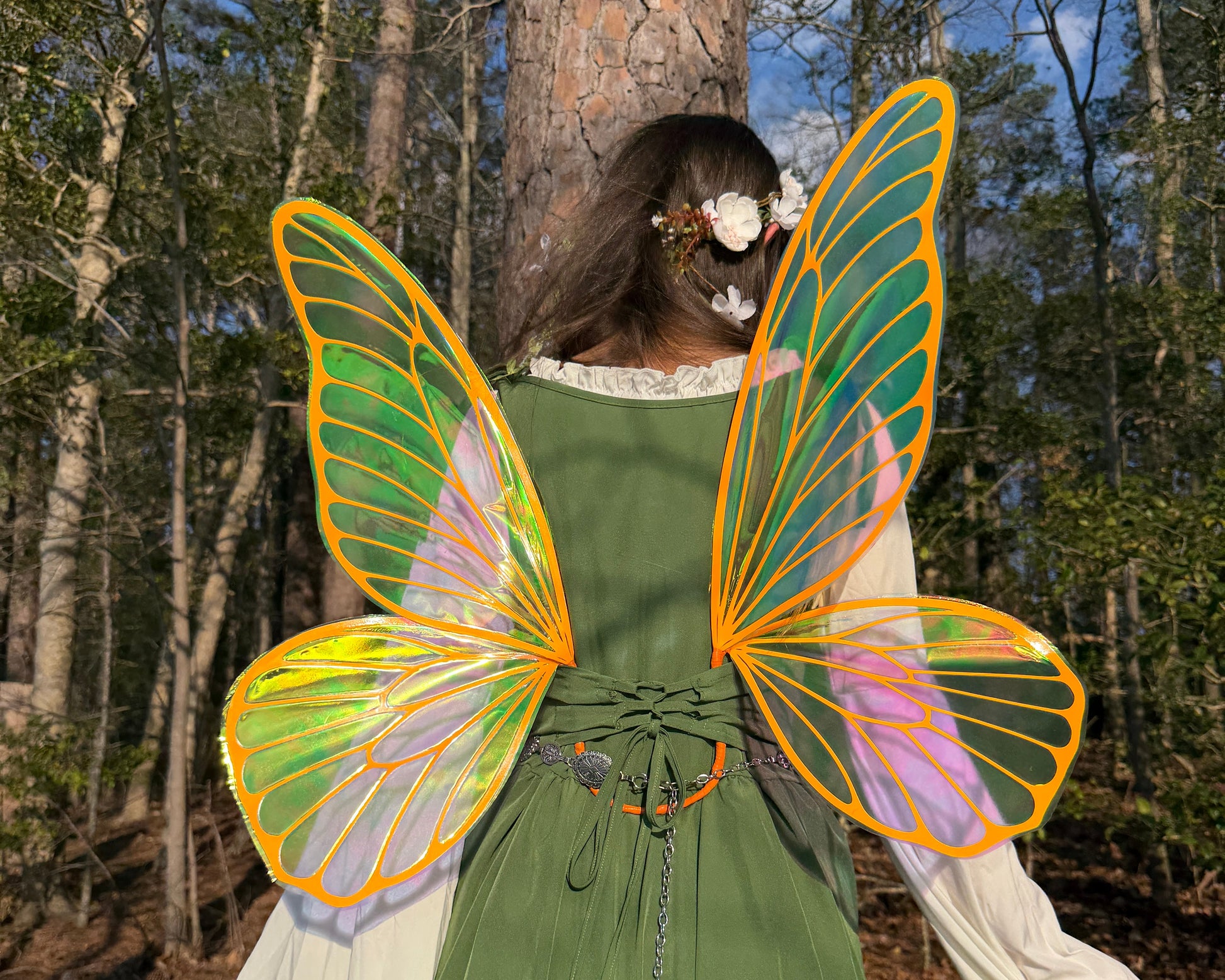 Translucent fairy wings with orange veins glowing in sunlight, fantasy costume accessory