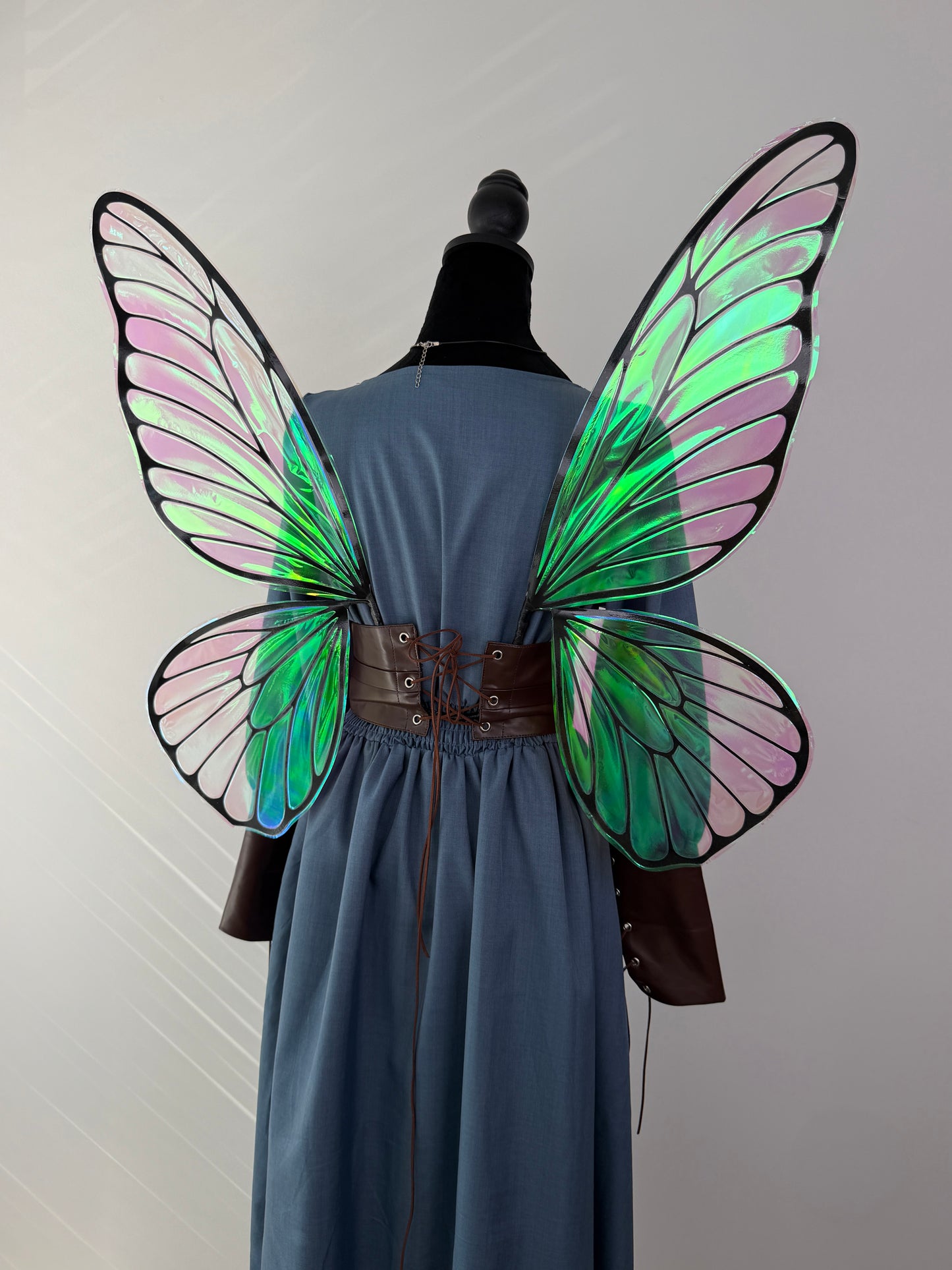 Close-up of the secure back attachment system on handcrafted butterfly fairy wings.