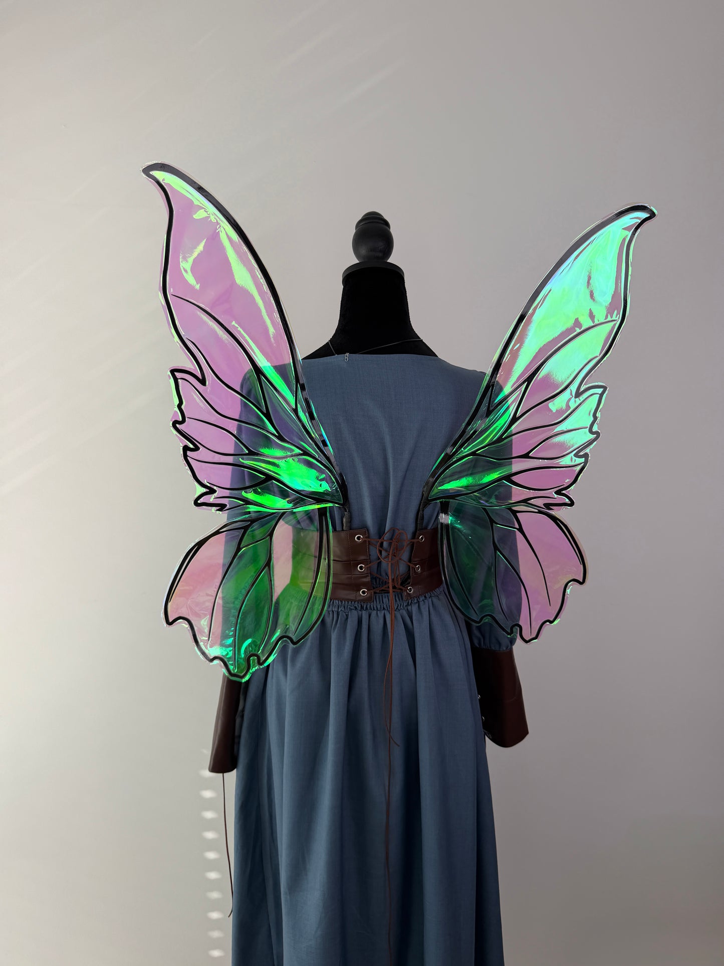 Close-up of handcrafted iridescent fae wings with decorative veins and reflective film