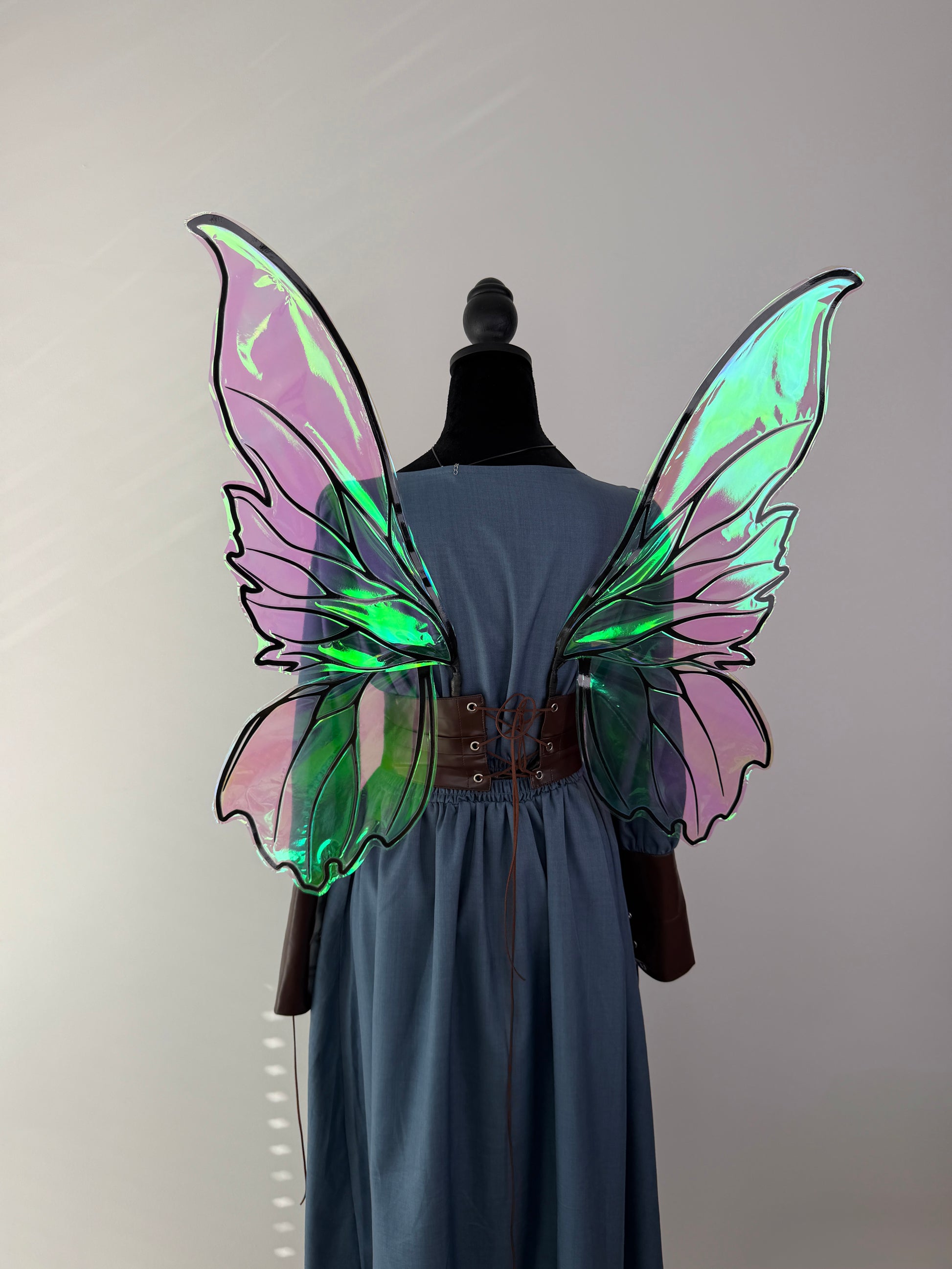 Close-up of handcrafted iridescent fae wings with decorative veins and reflective film