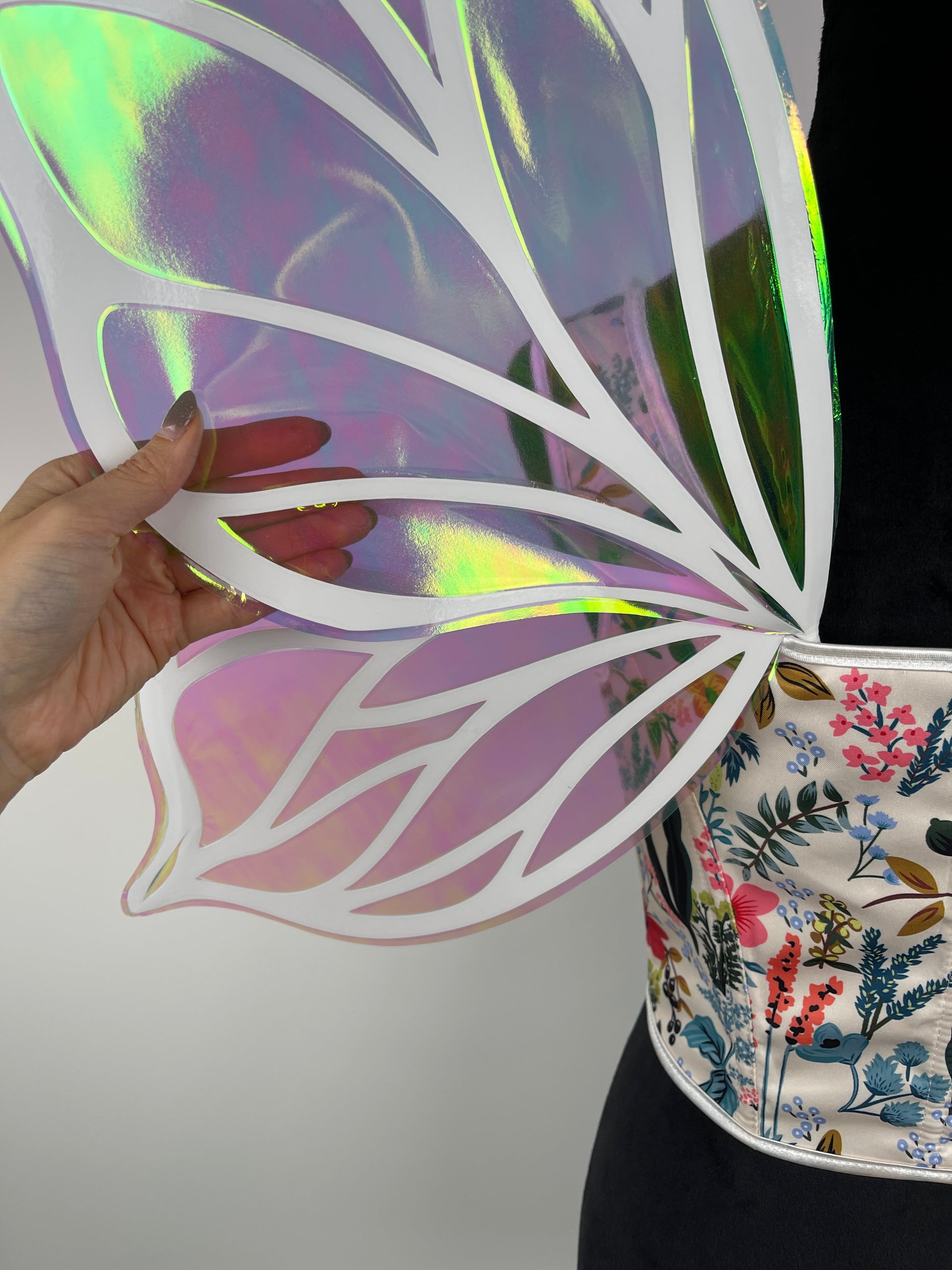 Closeup of handmade iridescent fairy wings showing holographic butterfly details