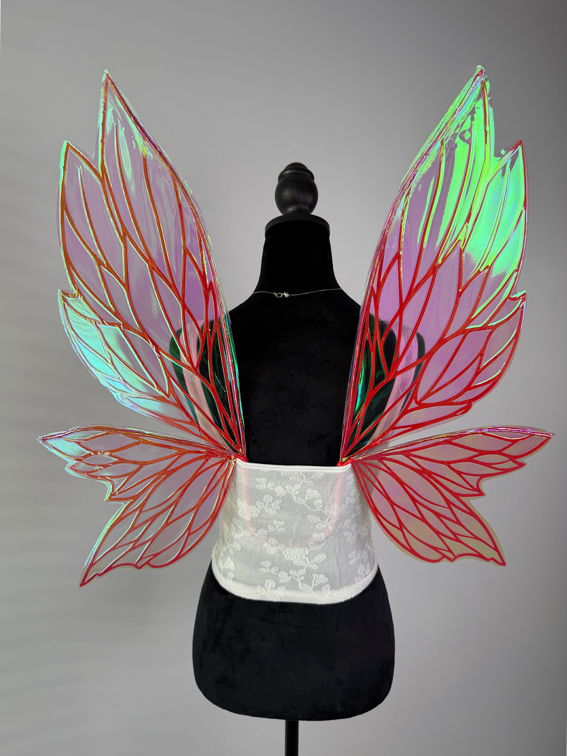 Iridescent fairy wings with red and orange veins and transparent leaf design for fantasy costume or cosplay