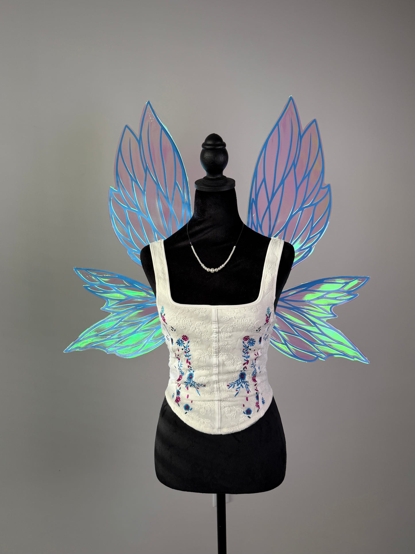 Iridescent pink fairy wings with blue veins and transparent leaf design for fantasy costume or cosplay