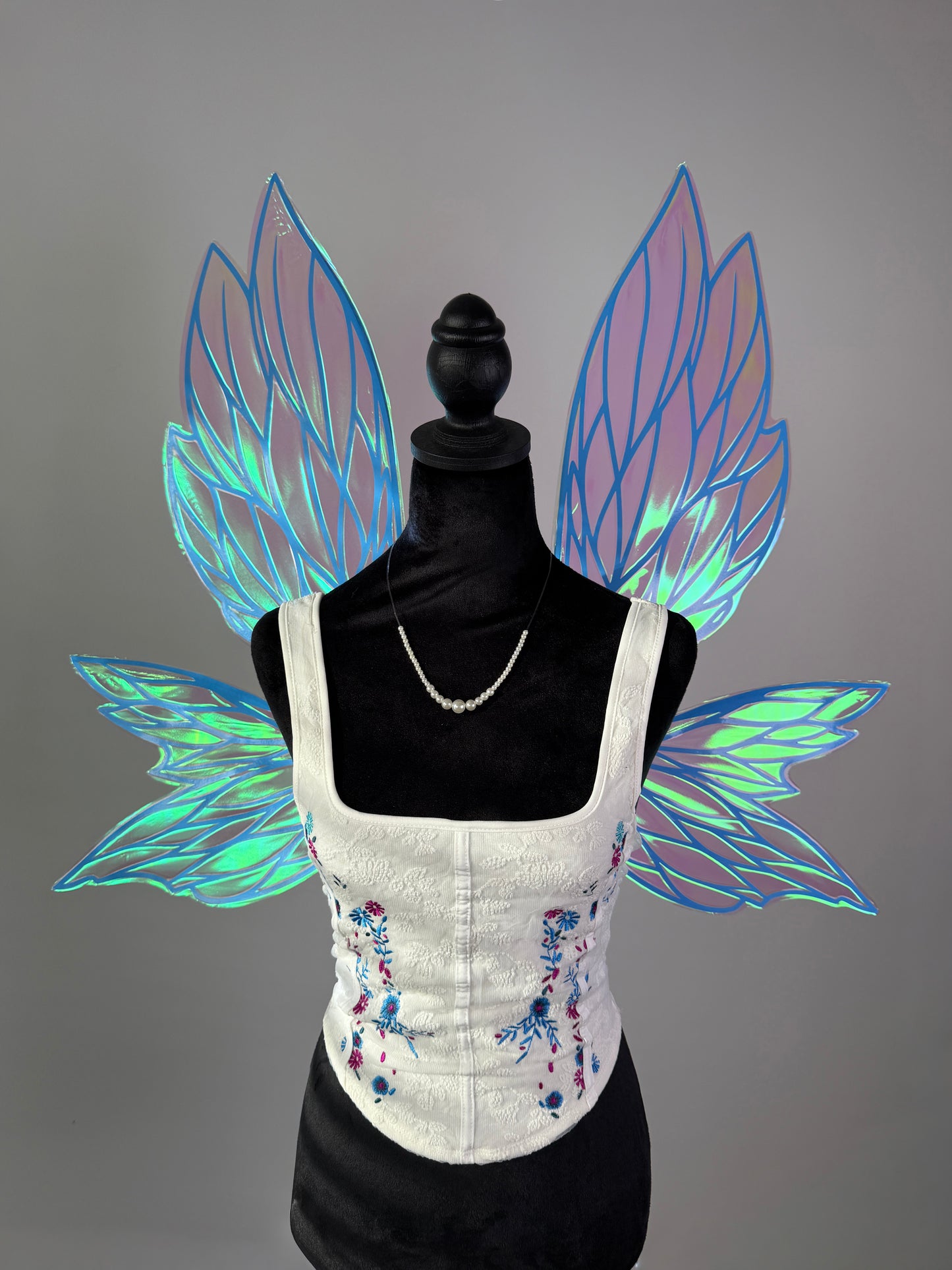 Large iridescent fairy wings in pink and blue with elegant leaf pattern for fairy costume