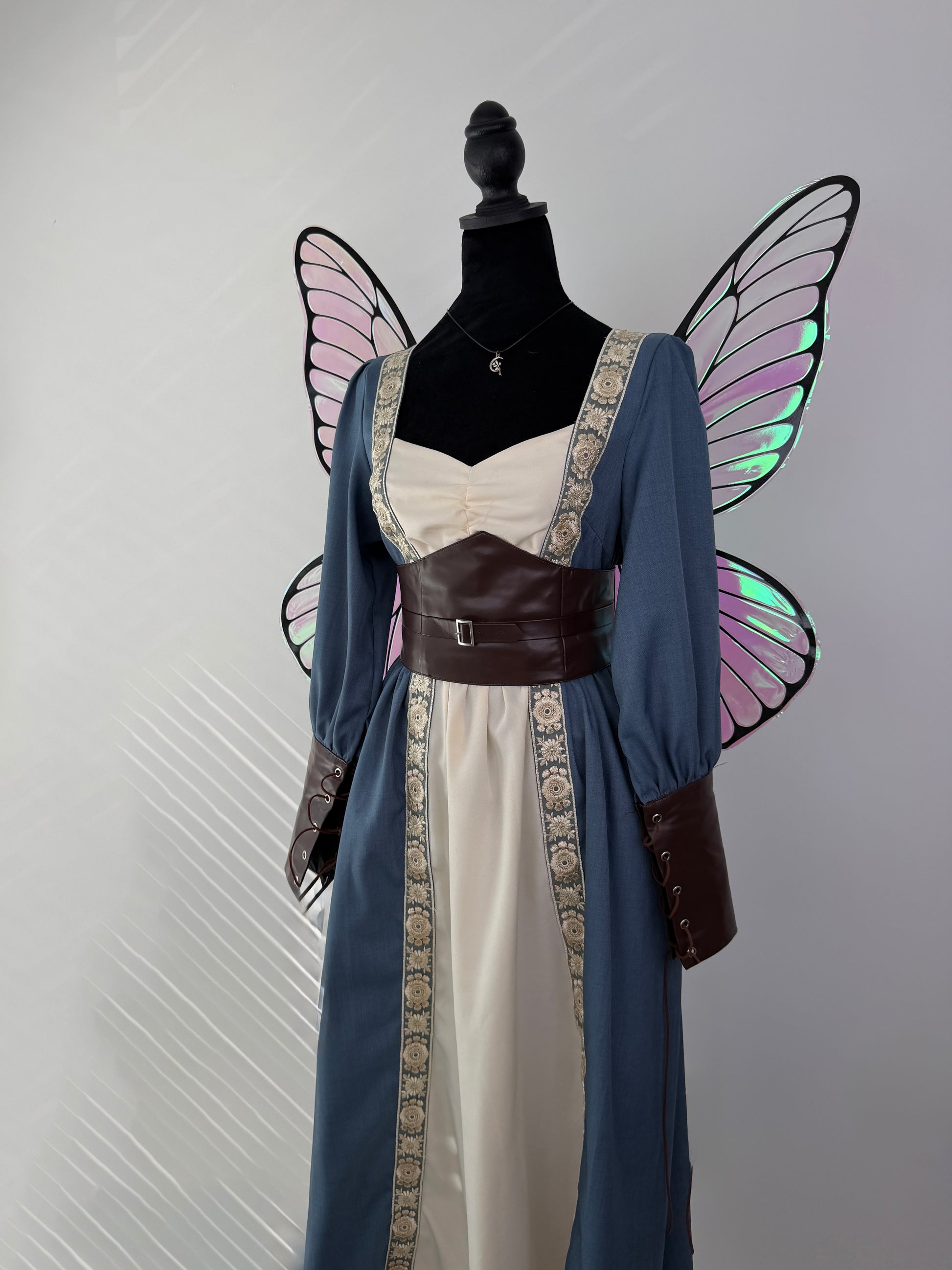 Elegant pink fairy wings with black veins and shimmering green reflections.