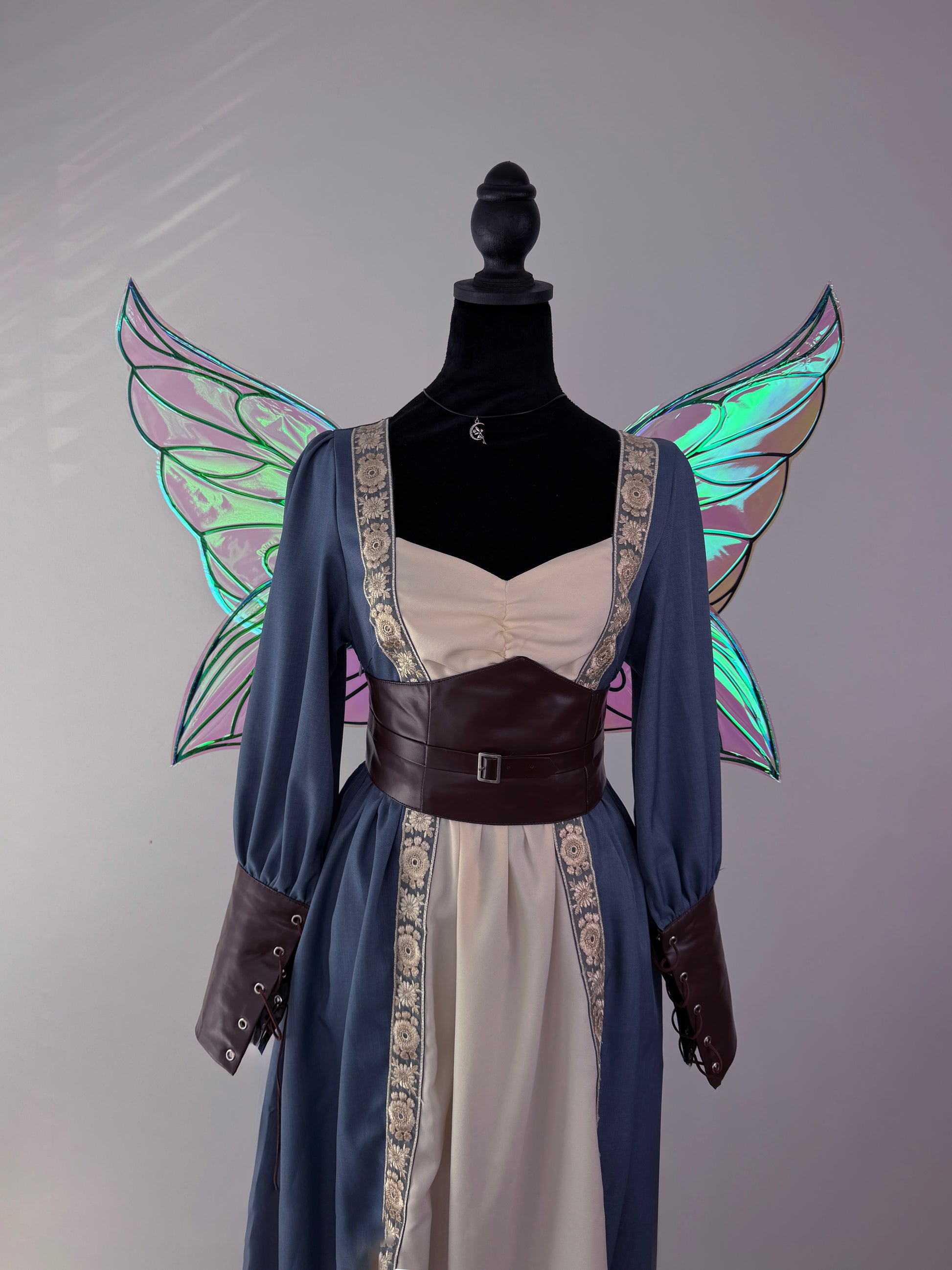Purple and green chameleon fairy wings displayed with a Renaissance-inspired costume