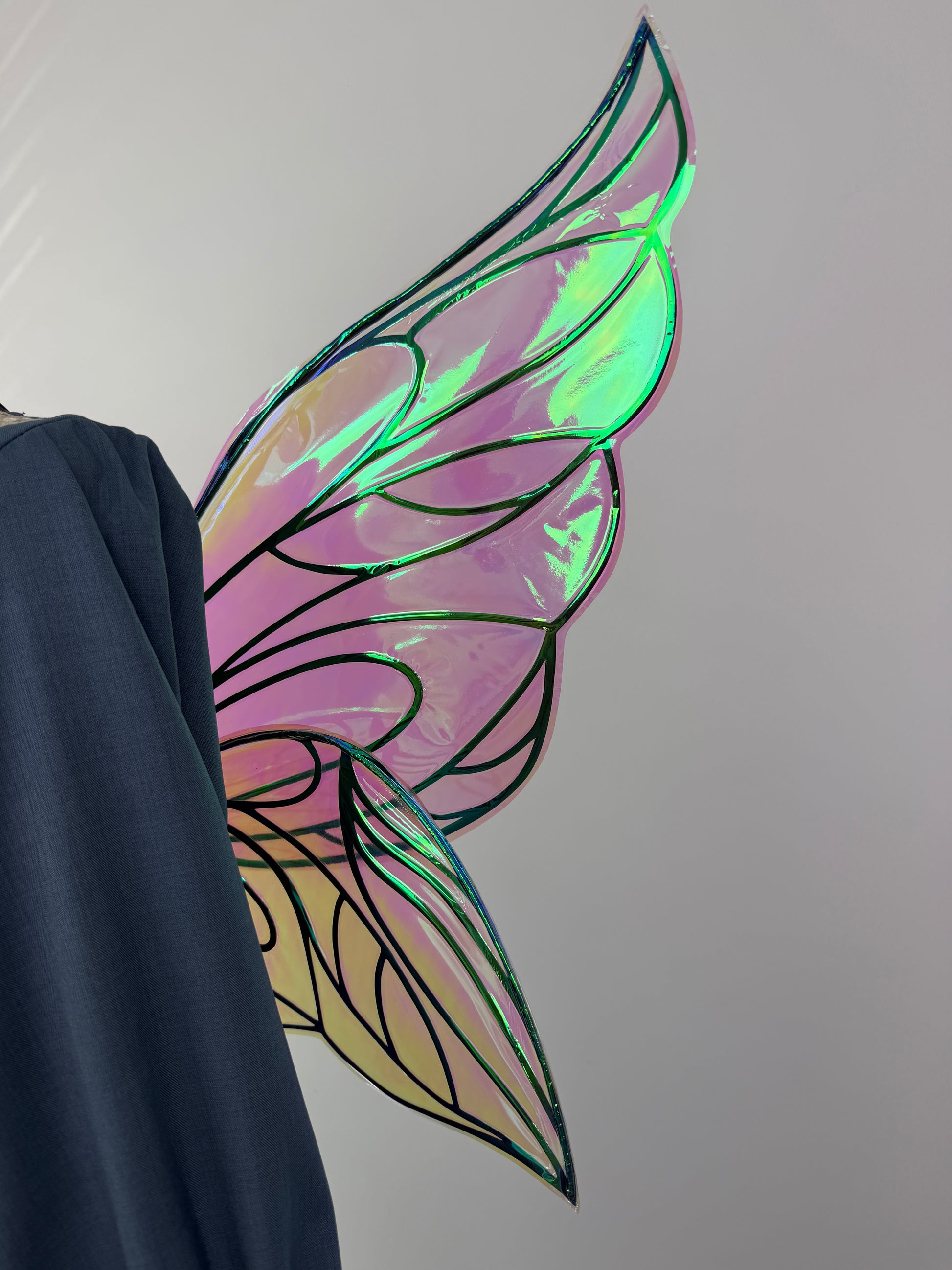Iridescent butterfly wings styled with a blue dress and corset for a Renaissance Faire