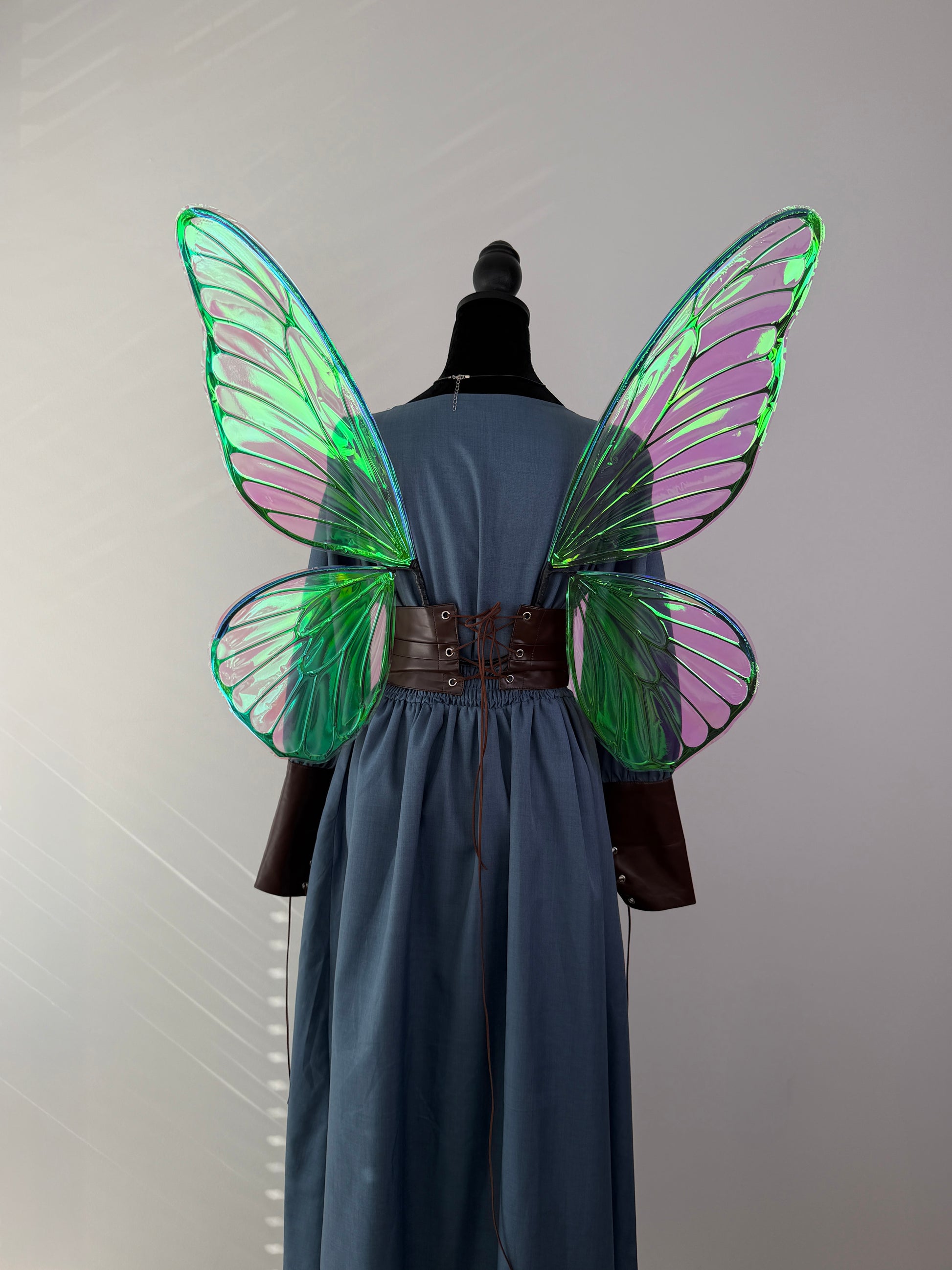 Large handmade fairy wings for Renaissance Faire costume with shimmering pink and emerald details.