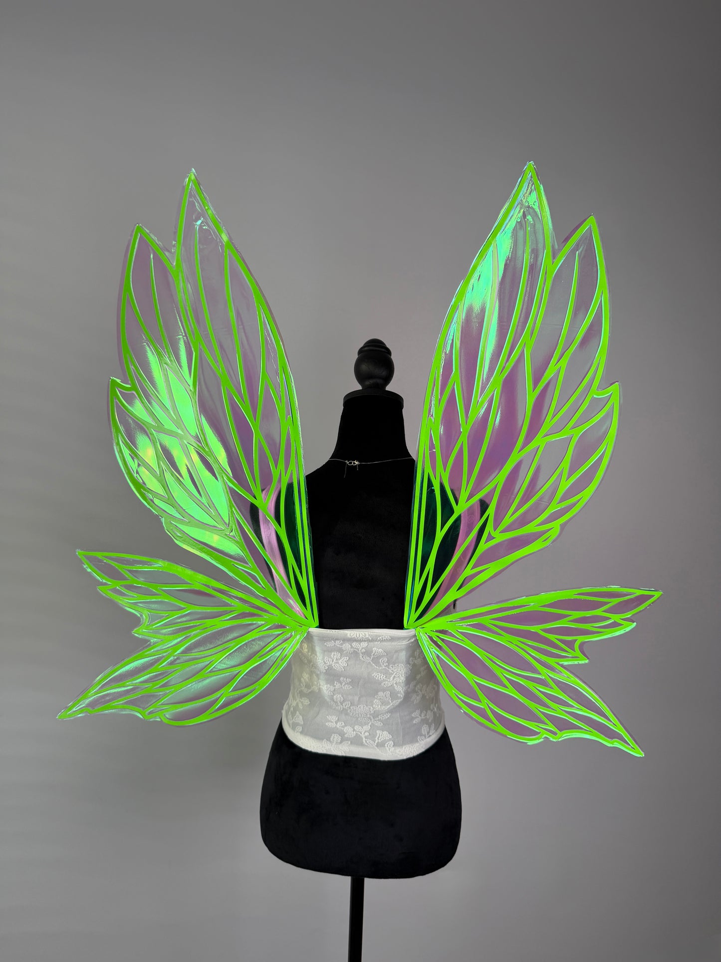 Transparent iridescent fairy wings with neon green leaf pattern for cosplay or fantasy outfit