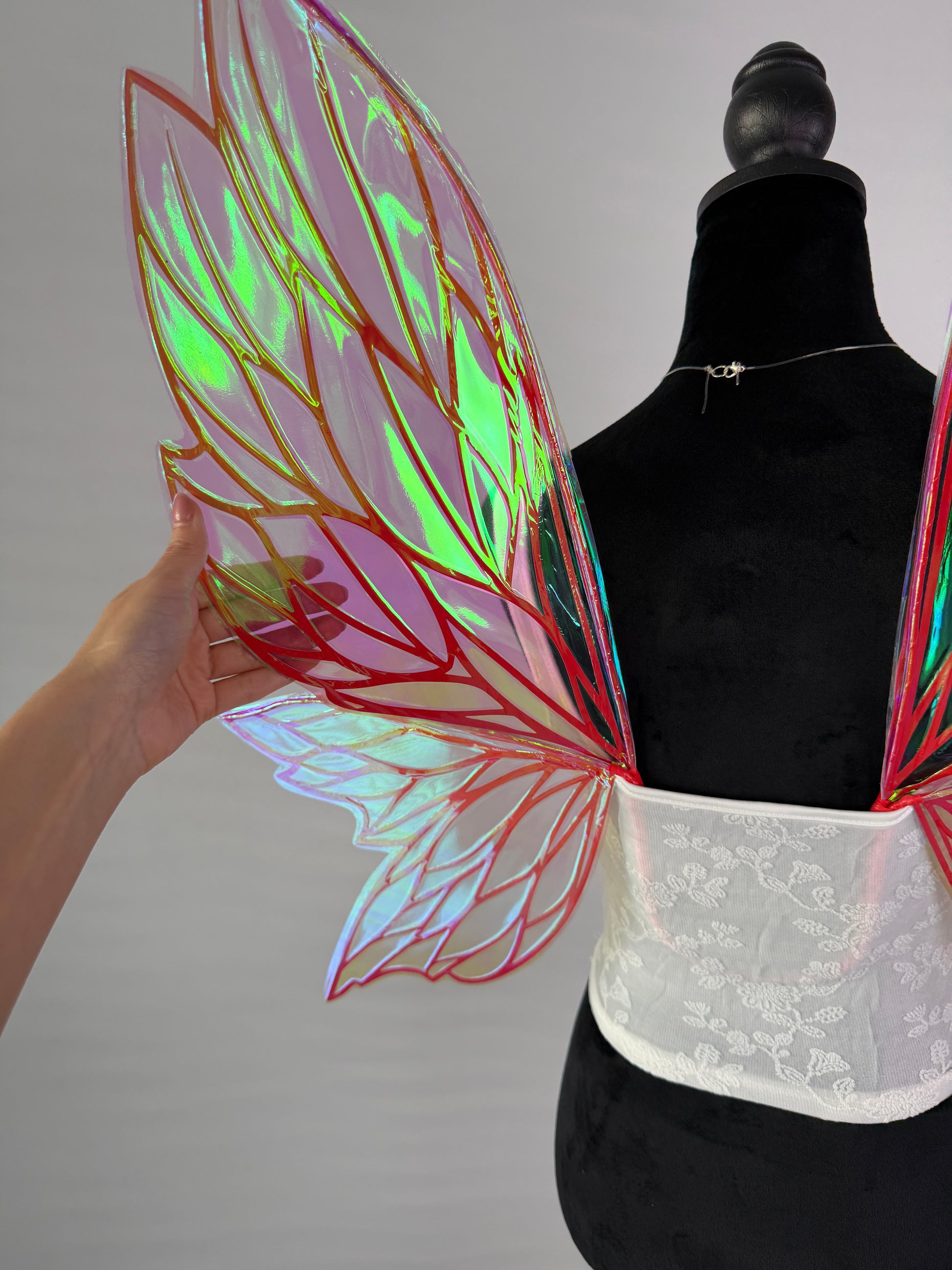 Transparent iridescent fairy wings with red orange leaf pattern for cosplay or fantasy outfit